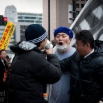 A fight breaks out between an anti-nuclear demonstrator and a nuclear energy defender during a protest against nuclear energy on March 11, 2012. Police and bystanders kept the men apart.